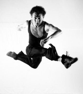 Novy Bereber mid-leap in a studio, photographed in black and white