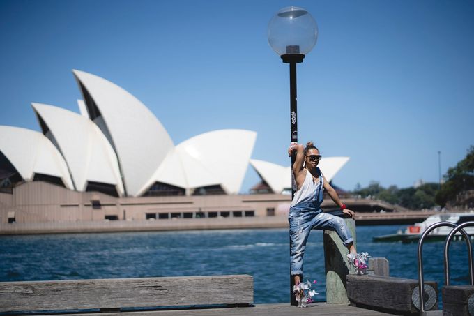 Novy Bereber posed against a lamp post on Sydney Harbour in sculptural stilettos, the Opera House behind him